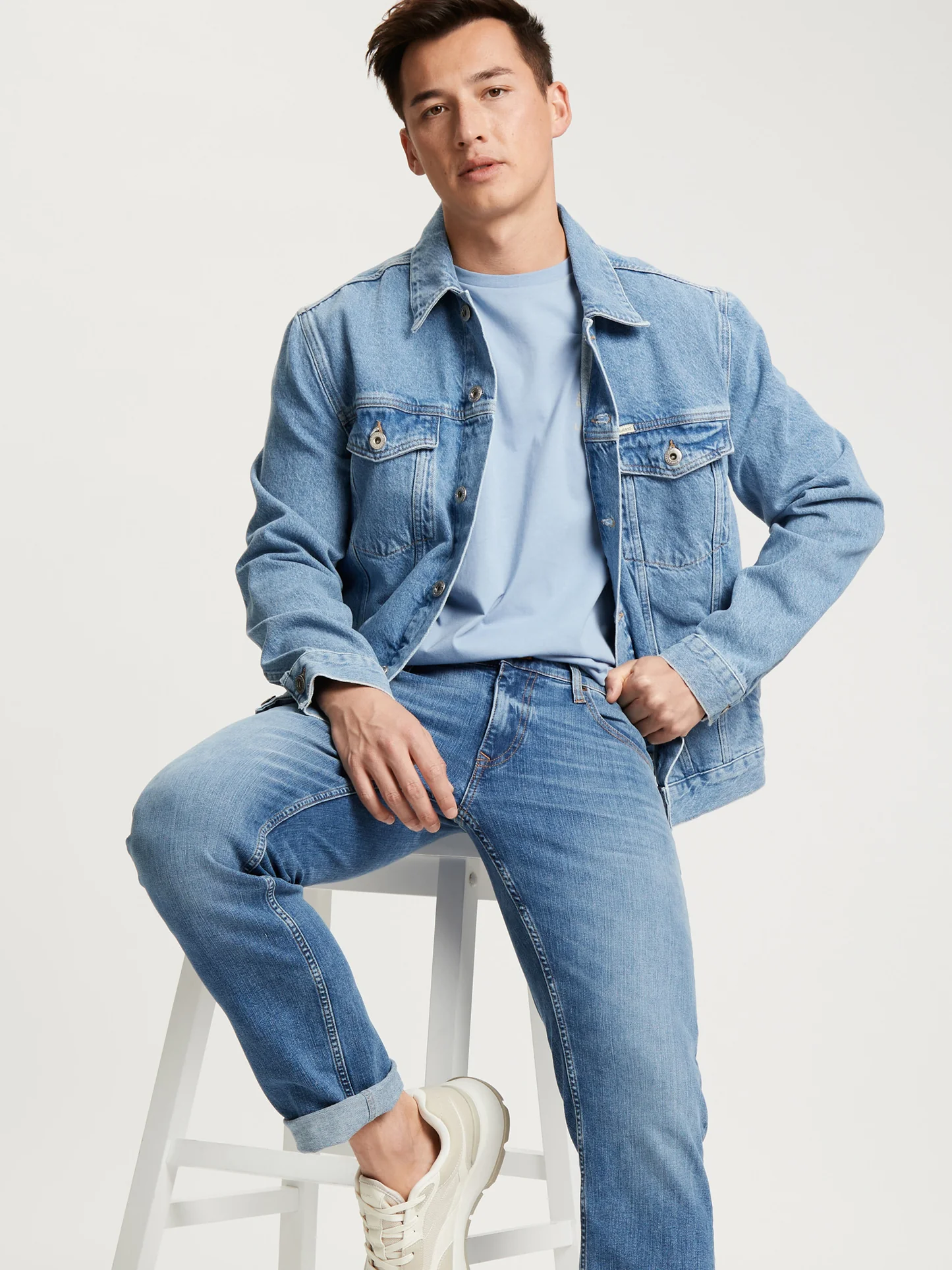 Olivia Clothing Store men's denim collection featuring a light blue denim jacket, matching jeans, and casual T-shirt for a modern everyday fashion look.