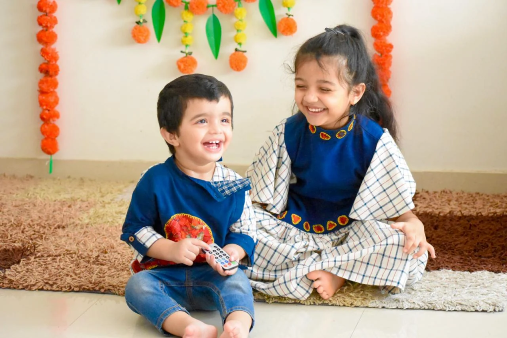 Olivia Clothing Store kids clothing collection featuring two smiling children wearing stylish ethnic outfits, showcasing comfortable festive wear and trendy apparel for boys and girls.